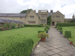 Large house Dutton Hall with stone pathway leading to entrance